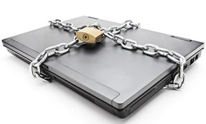 Heavy chain with a padlock around a laptop